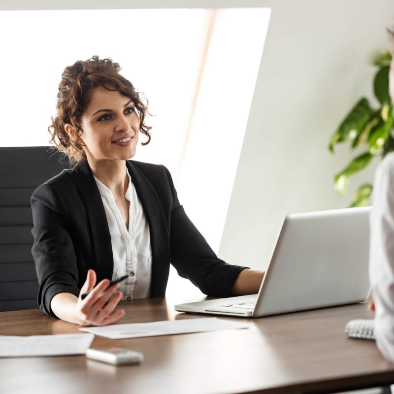 smiling-consultant-talking-to-a-client-on-a-business-meeting-portrait-.jpg